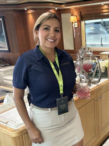 Chief Stewardess Alexandra on MY Invictus offering her “Coastal Bloom” drink